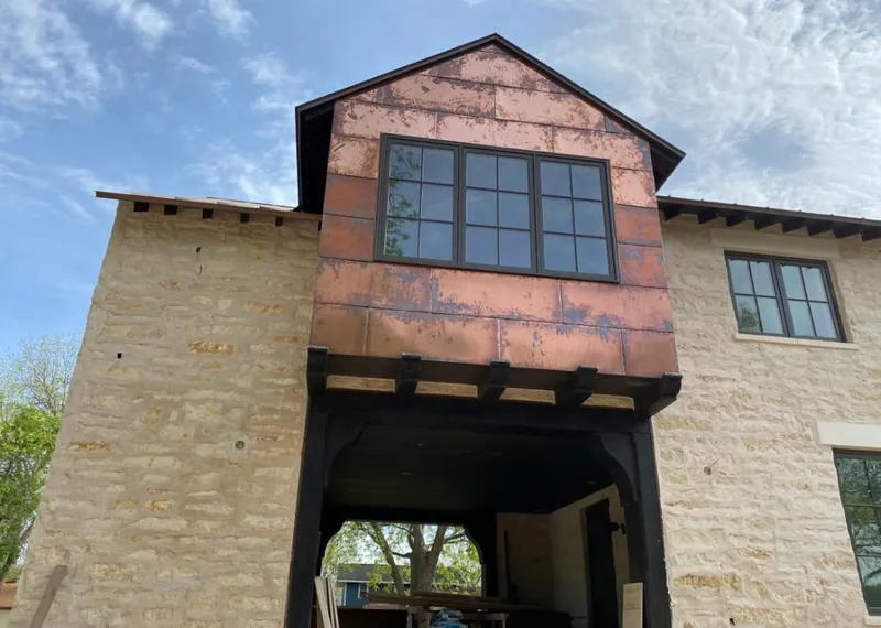 Copper metal panel facade on a stone building for Skylight Installation in Americus