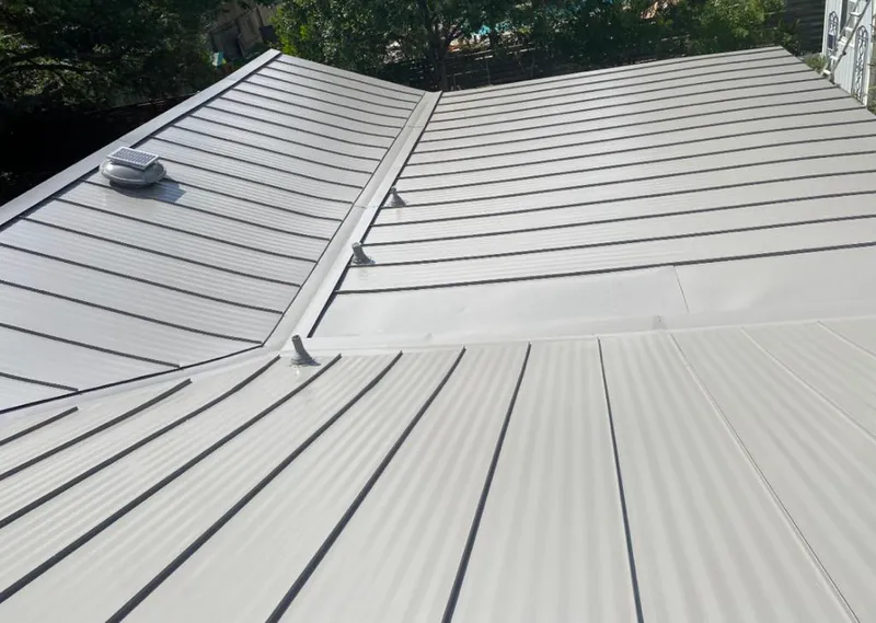 Solar attic fan installed on a metal roof for Roof Ventilation in Americus